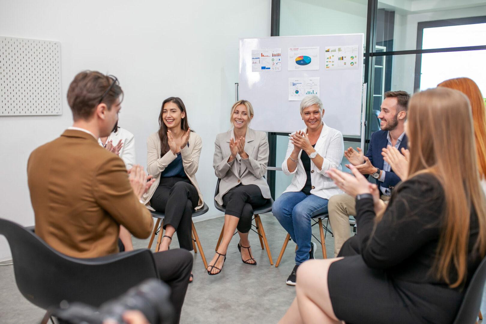 Business team male and female colleagues talking at work share i