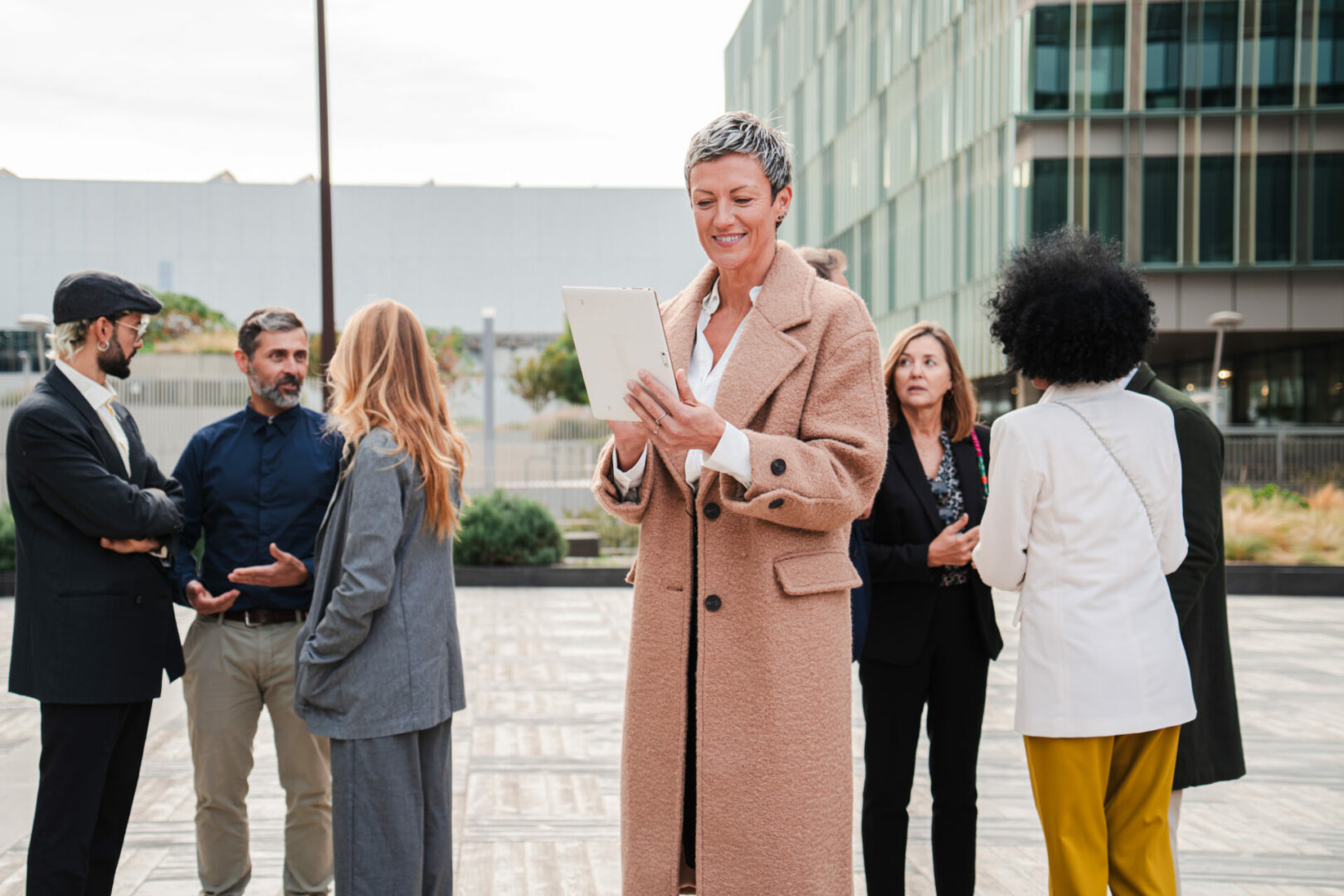 Successful businesswoman using a digital tablet to watch the enterprise data. mature corporate female or executive lady working outside, sending messagess and an e mail with a wireless touchpad