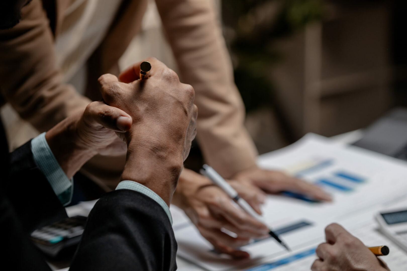 Three businesspeople are brainstorming together in a conference